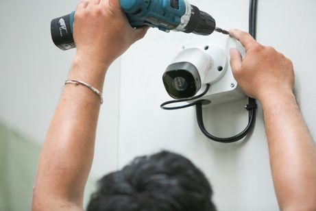 Technician mounting a CCTV camera