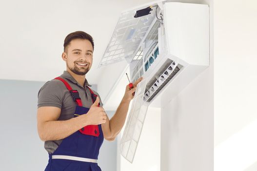 Technician servicing a split air-conditioning unit